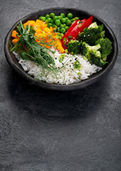 Bowl with rice, broccoli , pumpkin and microgreens.