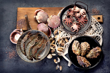 Fresh seafood arrangement on dark background.