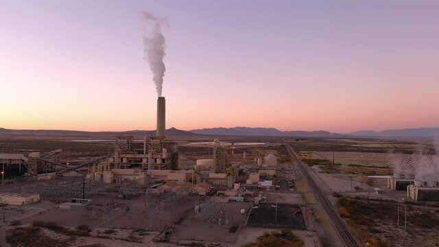 Willcox Arizona power plant with white smoke out of chimney, aerial 4k