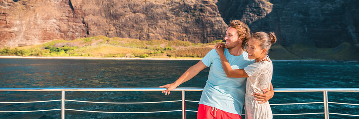 Luxury cruise ship travel couple of tourists on yacht vacation happy looking to the side on...