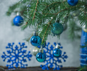 Fototapeta na wymiar Spruce branches decorated with blue Christmas toys