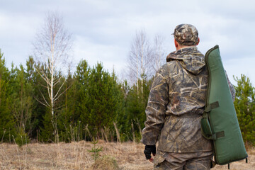 hunter with a gun in a case
