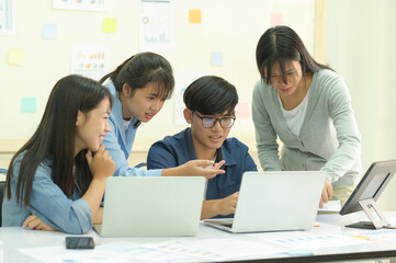 A group of young people brainstorming for work.