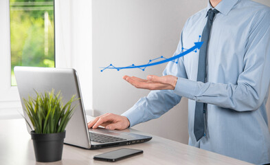 Businessman hold drawing on screen growing graph, arrow of positive growth icon.pointing at creative business chart with upward arrows.Financial, business growth concept.