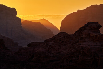 Wadi Rum desert, red send with stone and rock. Evening orange sunset in nature. Travel Jordan,...