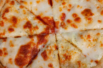 Delicious pizza cut into pieces