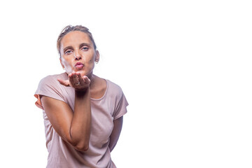 An adult woman sending air kiss on a white background