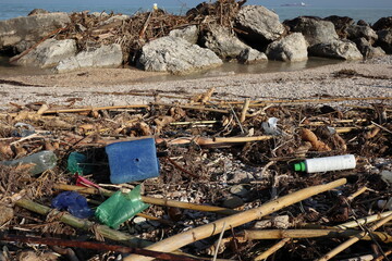 jerry cans and old plastic containers abandoned on the beach, pollution concept