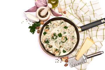 Delicious small meatballs with spinach in a creamy sauce in the frying pan