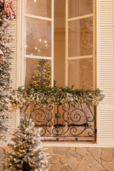 The snow-covered house is decorated for the new year. Vintage winter courtyard, decorated with New Year's decorations, Christmas trees, lanterns lights. Soft selective focus.