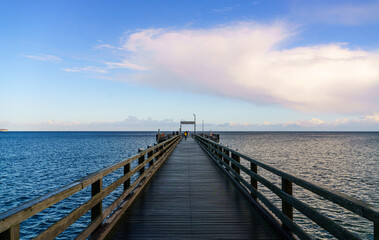 Fototapeta na wymiar Binz pier with wooden bridge and two-tone water