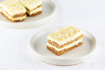 Fototapeta na wymiar Homemade sliced ​​lemon cake with almonds on a plate. Sugar, gluten and lactose free and vegan.