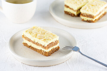 Sliced ​​lemon cake with almonds on a plate. Sugar, gluten and lactose free and vegan.