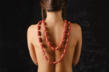 Young woman wearing small piccolini sausages as a beads