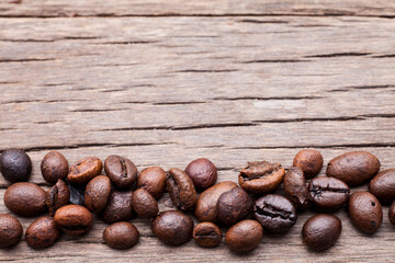Coffee beans on old wooden floor background..