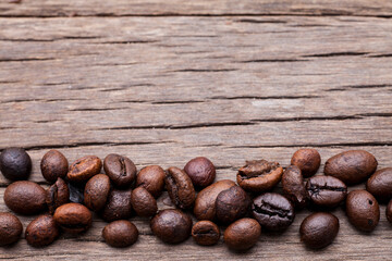 Coffee beans on old wooden floor background..