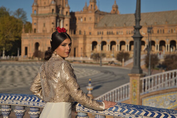 Portrait of young flamenco woman, Hispanic and brunette, with typical flamenco dance suit, with...