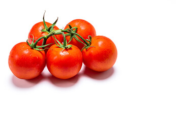 Photo of a bouquet of five wet red natural tomatoes on a white background.The photo has copy space.