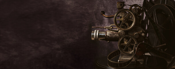 Antique cinema projector on neutral background with copy space.