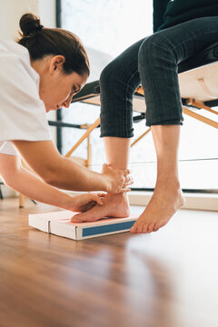 Chiropodist taking the shape of a patient's foot with a foam mold for the manufacture of a special insole.