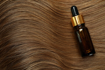Naklejka premium Dark female hair with cosmetic on whole background