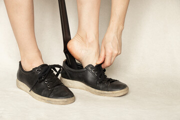 girl shoes black sneakers with a shoehorn on a white background, shoes, women's sneakers