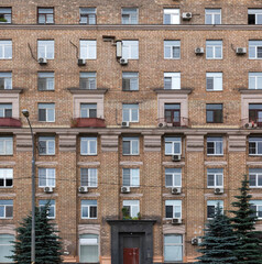 Obraz premium Vintage architecture classical brick facade residential building decorated stucco molding soviet symbolic front view