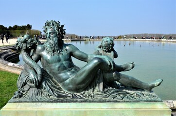 Statue in the gardens of Versailles Palace, Paris (France)