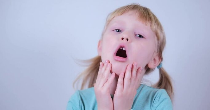Pretty blond kid Child Girl Looking with Blue Eyes and Is Surprised Happy.