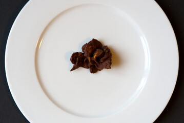 Corn flakes chocolate cookie on white plate. Photo taken December 29th, 2021, Zurich, Switzerland.