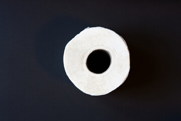 White toilet paper roll against black background. Photo taken December 29th, 2021, Zurich, Switzerland.