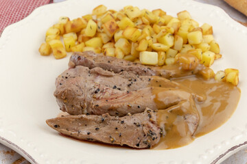stewed meat and hash browns on a plate