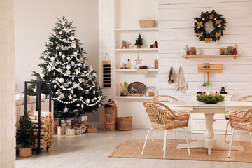 Cozy dining room interior with Christmas tree and festive decor