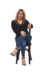 Fototapeta premium front view of portrait of a woman with jeans and heeled shoes looking at camera and legs crossed on white background