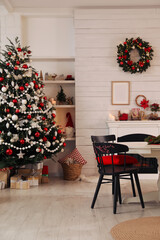 Cozy dining room interior with Christmas tree and festive decor
