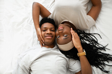 portrait of beautiful loving african couple lying on bed 