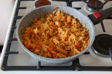 Cabbage is stewed in a pan on the stove
