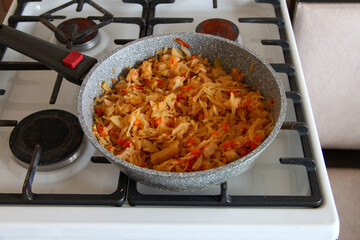 Cabbage is stewed in a pan on the stove