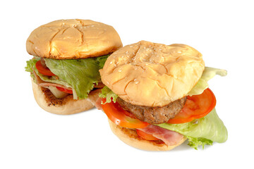 Close up of fresh homemade pork burgers with tomatoes, cheese, ham, lettuce and onion. Clipping path.