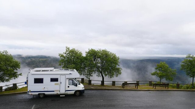 Caravan camping in mountains at Penedo Durao lookout in north Portugal. Rainy cloudy weather. Traveling by motorhome. Place to visit.
