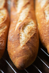 Batch of freshly baked baguettes background.