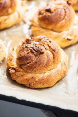 Freshly baked nuts and cardamom sweet buns. Yeasted pastry and cozy baking.