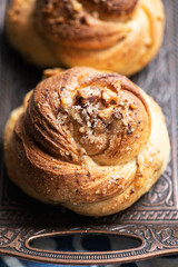 Freshly baked nuts and cardamom sweet buns. Yeasted pastry and cozy baking.