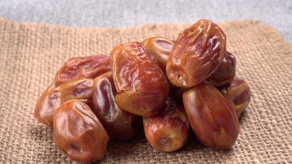 Dates in wooden bowl on background. dried dates fruit.