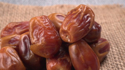 Dates in wooden bowl on background. dried dates fruit.