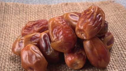Dates in wooden bowl on background. dried dates fruit.