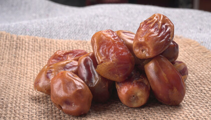 Dates in wooden bowl on background. dried dates fruit.