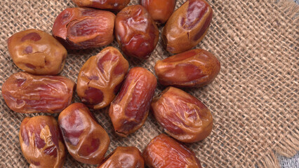 Dates in wooden bowl on background. dried dates fruit.
