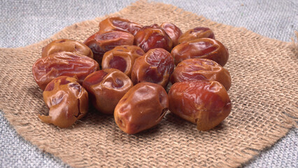 Dates in wooden bowl on background. dried dates fruit.