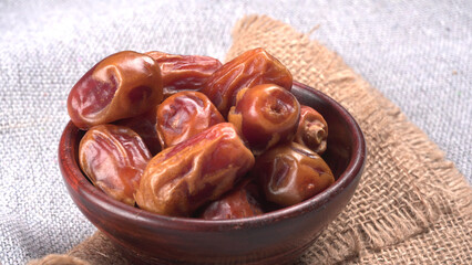 Dates in wooden bowl on background. dried dates fruit.